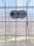 Electric window cleaning robot on glass